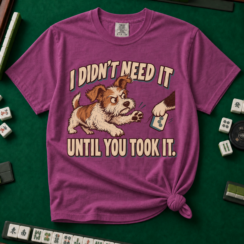 I Didn't Need It Until You Took It T-Shirt in Berry - knotted tee on a green mahjong mat with scattered tiles, printed with a scruffy puppy lunging for a tile as another paw takes it away, and the words I Didn't Need It Until You Took It