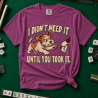 I Didn't Need It Until You Took It T-Shirt in Berry - knotted tee on a green mahjong mat with scattered tiles, printed with a scruffy puppy lunging for a tile as another paw takes it away, and the words I Didn't Need It Until You Took It
