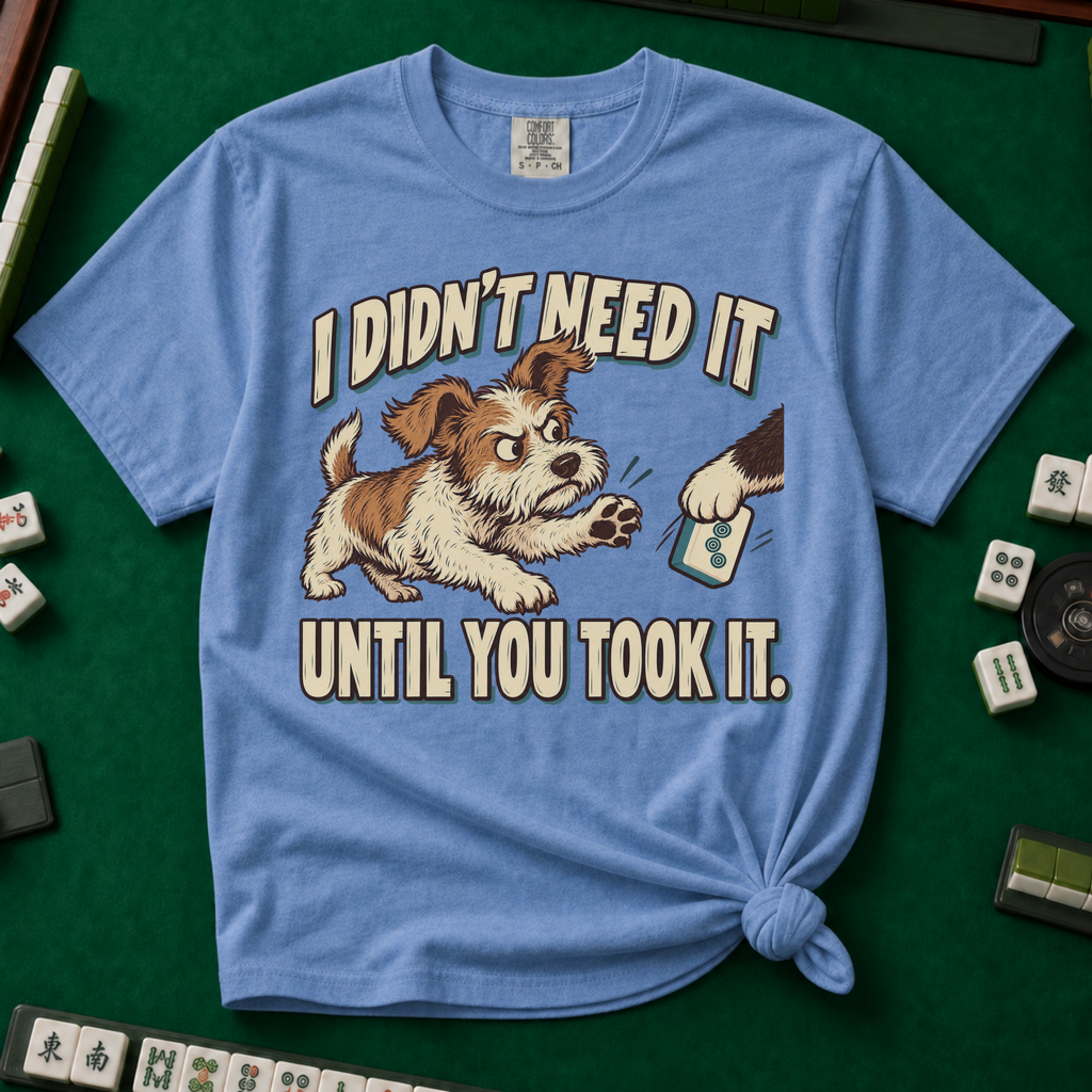 I Didn't Need It Until You Took It T-Shirt in Blue Jean - knotted tee on a green mahjong mat with scattered tiles, printed with a scruffy puppy lunging for a tile as another paw takes it away, and the words I Didn't Need It Until You Took It