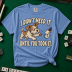 I Didn't Need It Until You Took It T-Shirt in Blue Jean - knotted tee on a green mahjong mat with scattered tiles, printed with a scruffy puppy lunging for a tile as another paw takes it away, and the words I Didn't Need It Until You Took It
