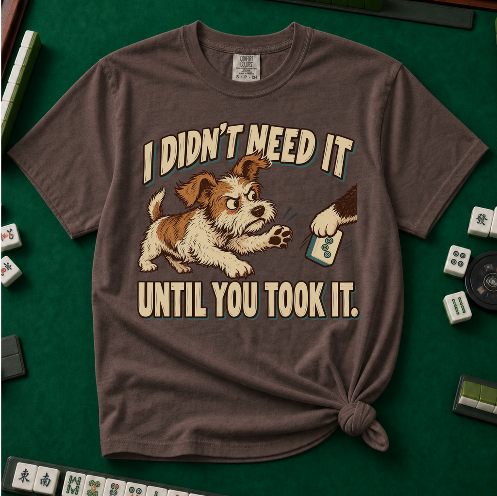 I Didn't Need It Until You Took It T-Shirt in Espresso - knotted tee on a green mahjong mat with scattered tiles, printed with a scruffy puppy lunging for a tile as another paw takes it away, and the words I Didn't Need It Until You Took It