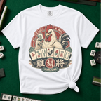 Cluck And Win Mahjong Rooster T-Shirt in White - knotted tee on a green mahjong mat with scattered tiles, printed with a rooster holding a green dragon tile above a fan of mahjong tiles in a red Cluck and Win badge