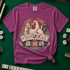 Cluck And Win Mahjong Rooster T-Shirt in Berry - knotted tee on a green mahjong mat with scattered tiles, printed with a rooster holding a green dragon tile above a fan of mahjong tiles in a red Cluck and Win badge