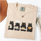 Four black cats making sourdough from starter to finished loaf on an Ivory Comfort Colors T-shirt.
