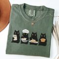 Four black cats making sourdough from starter to finished loaf on an Espresso Comfort Colors T-shirt.