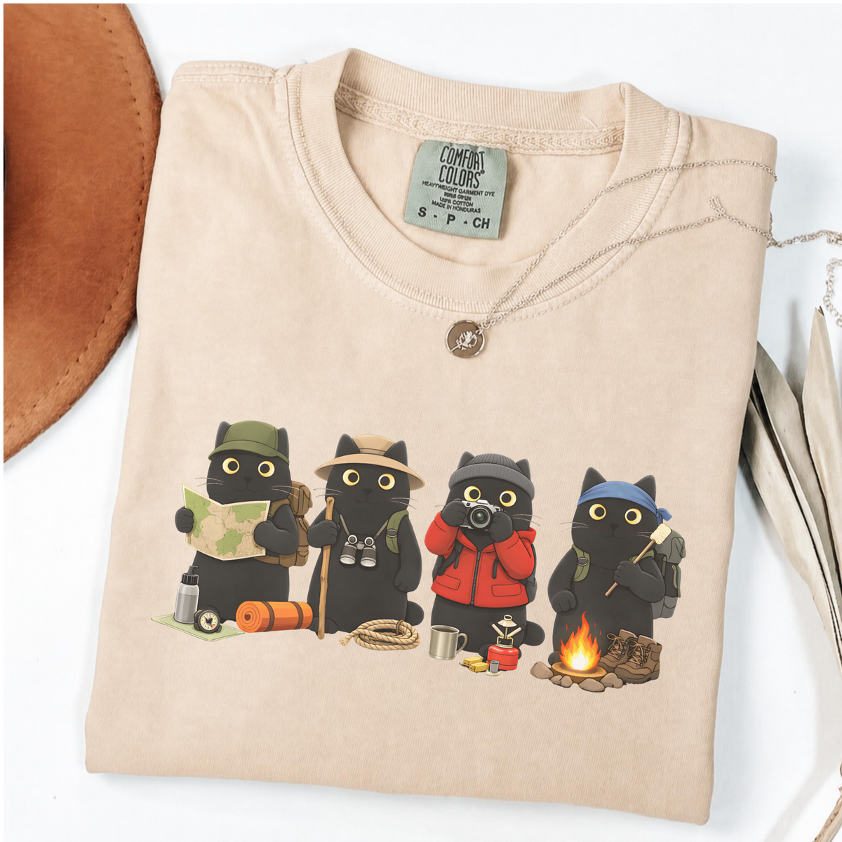 Four black cats hiking and camping on a Ivory Comfort Colors T-shirt
