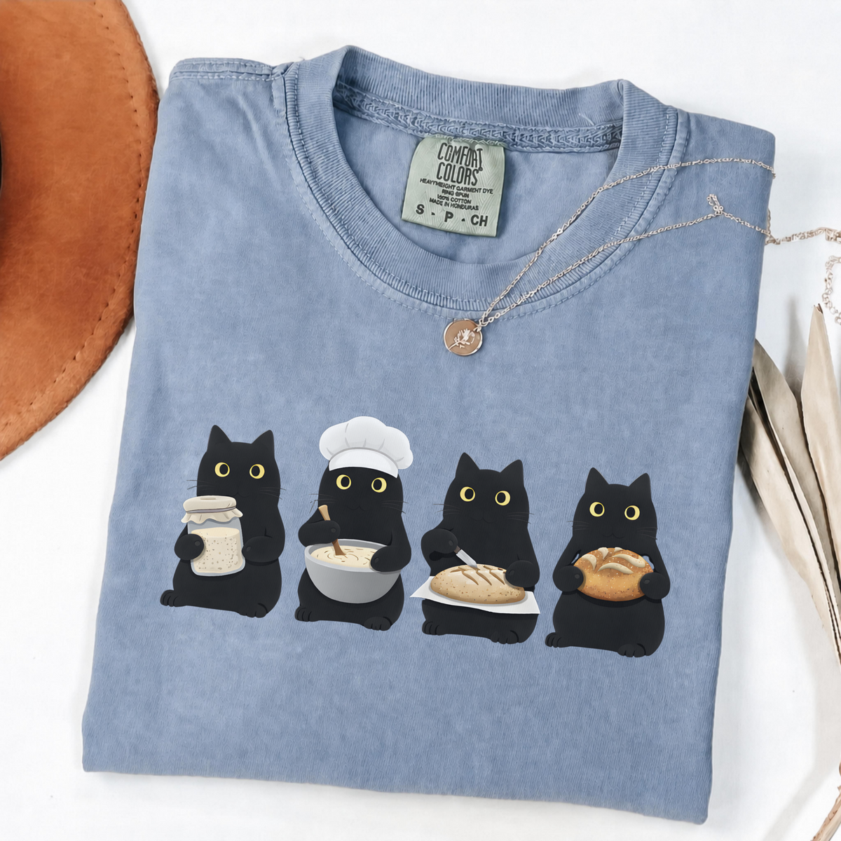 Four black cats making sourdough from starter to finished loaf on an Blue Jean Comfort Colors T-shirt.