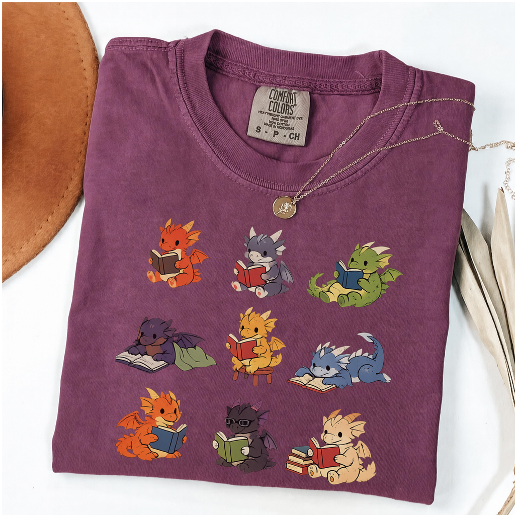 Nine colourful bookish dragons reading on an Berry Comfort Colors T-shirt