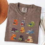 Nine colourful bookish dragons reading on an Espresso Comfort Colors T-shirt