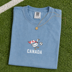 Embroidered Canada Soccer Goose Shirt – Jean Blue flat lay