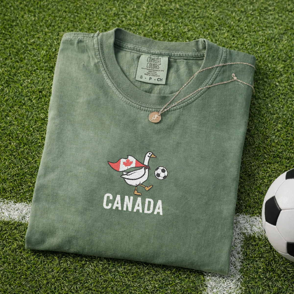 Embroidered Canada Soccer Goose Shirt – Moss flat lay