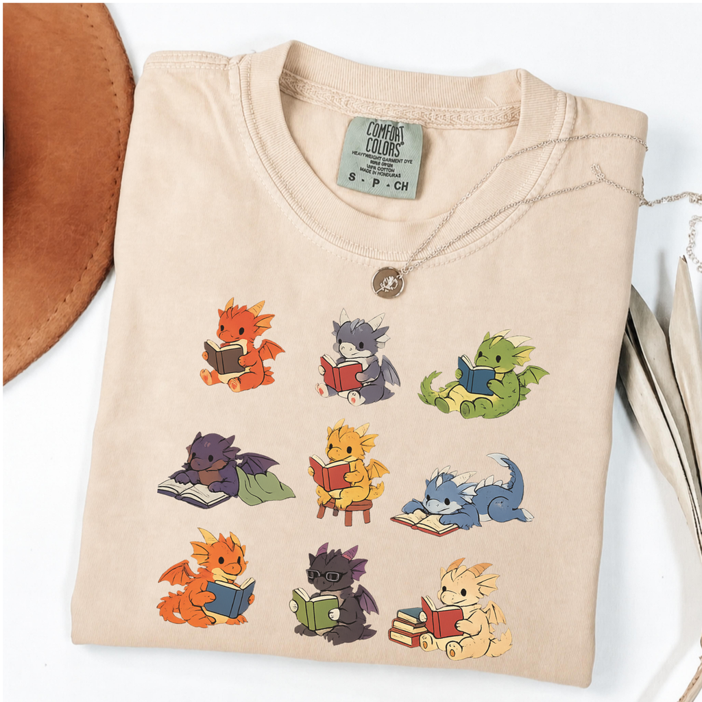 Nine colourful bookish dragons reading on an Ivory Comfort Colors T-shirt
