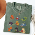 Nine colourful bookish dragons reading on an Moss Comfort Colors T-shirt