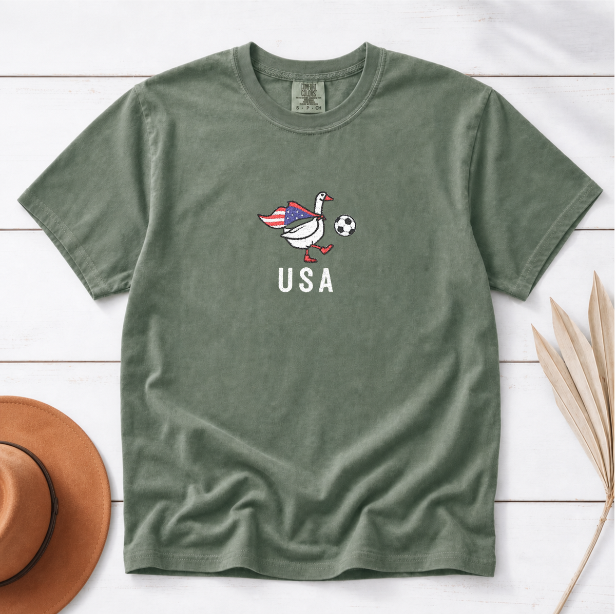 USA Soccer Goose embroidered shirt – Moss flat lay