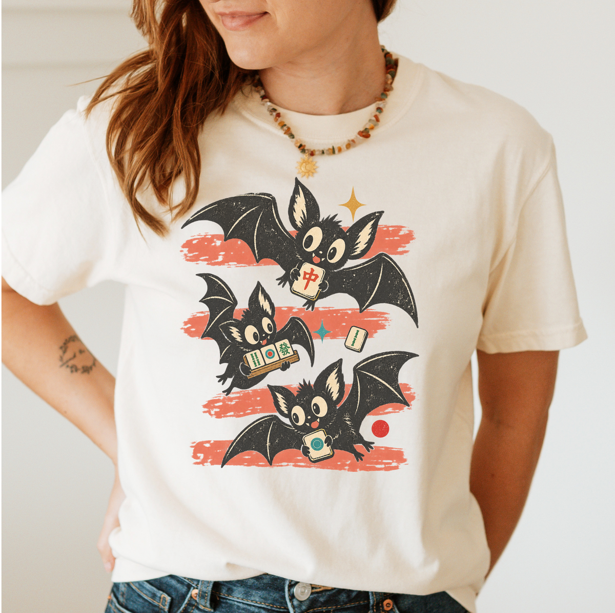 Model wearing the Bats Out mahjong Halloween shirt in Ivory