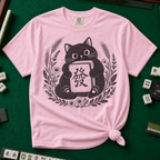 Linocut Tile Cat T-Shirt in Blossom, knotted flat lay on a green mahjong mat - a linocut-style black cat hugging a Green Dragon mahjong tile inside a wreath of wheat, daisies and lavender