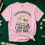 I Said Good Luck T-Shirt in Blossom - knotted tee flat lay on a green mahjong mat with tiles, printed with a cream poodle in a pink scarf holding a teacup behind a rack of mahjong tiles, with the words I SAID GOOD LUCK. I MEANT TO ME.
