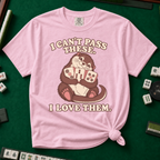 I Can't Pass These I Love Them T-Shirt in Blossom, knotted flat lay on a green mahjong mat - lovestruck otter hugging three mahjong tiles to her chest - "I CAN'T PASS THESE. I LOVE THEM." in cream retro letters