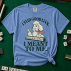 I Said Good Luck T-Shirt in Blue Jean - knotted tee flat lay on a green mahjong mat with tiles, printed with a cream poodle in a pink scarf holding a teacup behind a rack of mahjong tiles, with the words I SAID GOOD LUCK. I MEANT TO ME.