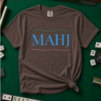 MAHJ Wave T-Shirt in Espresso, knotted flat lay on a green mahjong mat - "MAHJ" in sky-blue serif letters between a teal wave line above and a pink wave line below