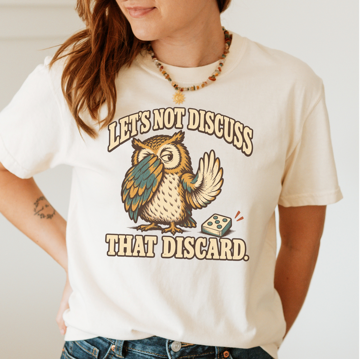 Model wearing Let's Not Discuss That Discard T-Shirt in Ivory