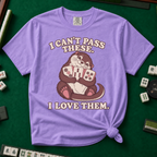 I Can't Pass These I Love Them T-Shirt in Violet, knotted flat lay on a green mahjong mat - lovestruck otter hugging three mahjong tiles to her chest - "I CAN'T PASS THESE. I LOVE THEM." in cream retro letters
