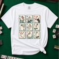 Mahjong Chicken Tiles T-Shirt in White, knotted flat lay on a green mahjong mat - a 3x3 grid of mahjong tiles, each starring a cartoon chicken with its own personality - varsity jacket, karate gi, cape, beanie, headphones, bookworm glasses, cherry blossom, pool floatie and skateboard