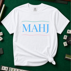 MAHJ Wave T-Shirt in White, knotted flat lay on a green mahjong mat - "MAHJ" in sky-blue serif letters between a teal wave line above and a pink wave line below