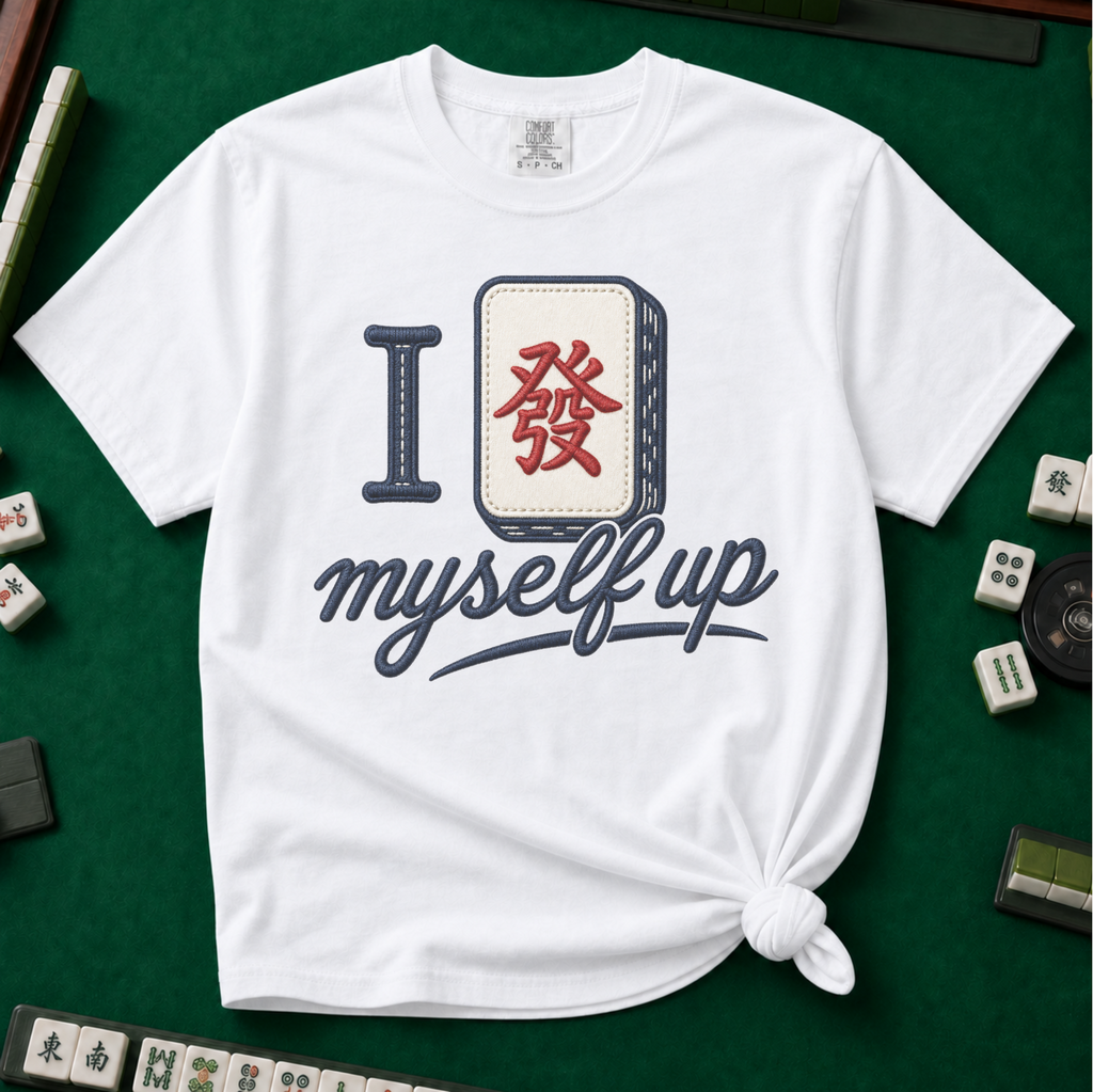 I Set Myself Up T-Shirt in White, knotted flat lay on a green mahjong mat - a stitched-look varsity rebus - a navy letter I beside a cream fa dragon tile with the red character, over "myself up" in navy script