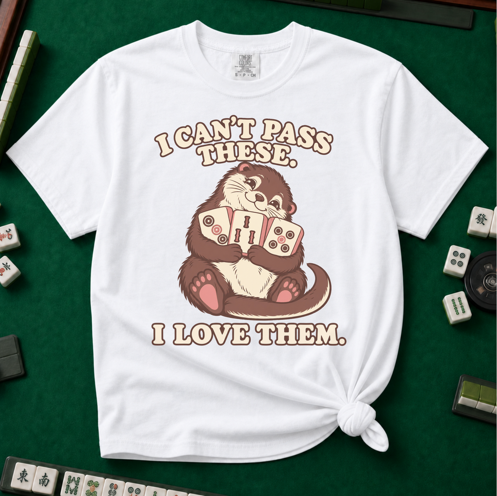 I Can't Pass These I Love Them T-Shirt in White, knotted flat lay on a green mahjong mat - lovestruck otter hugging three mahjong tiles to her chest - "I CAN'T PASS THESE. I LOVE THEM." in cream retro letters