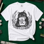 Linocut Tile Cat T-Shirt in White, knotted flat lay on a green mahjong mat - a linocut-style black cat hugging a Green Dragon mahjong tile inside a wreath of wheat, daisies and lavender