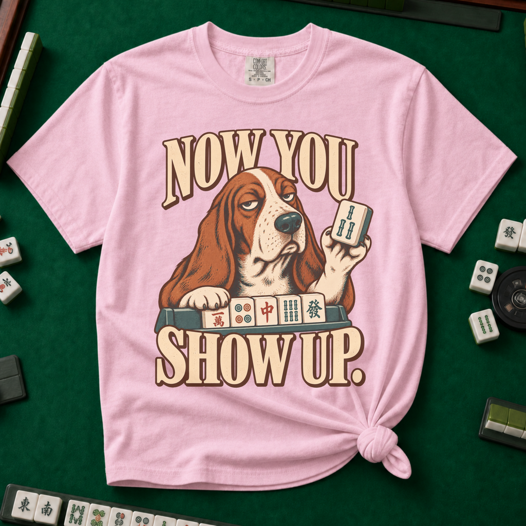 Now You Show Up Shirt in Blossom - knotted tee on a green mahjong mat with scattered tiles, printed with a basset hound peeking over a row of mahjong tiles and the words Now You Show Up
