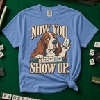 Now You Show Up Shirt in Blue Jean - knotted tee on a green mahjong mat with scattered tiles, printed with a basset hound peeking over a row of mahjong tiles and the words Now You Show Up