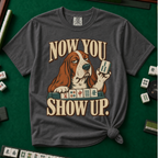 Now You Show Up Shirt in Pepper - knotted tee on a green mahjong mat with scattered tiles, printed with a basset hound peeking over a row of mahjong tiles and the words Now You Show Up
