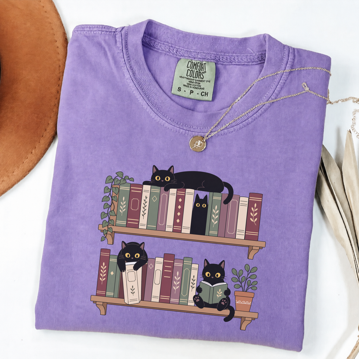 Violet Comfort Colors book-lover shirt featuring black cats among colourful bookshelves