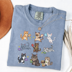 Blue Jean graphic T-shirt with nine cartoon cats playing pickleball