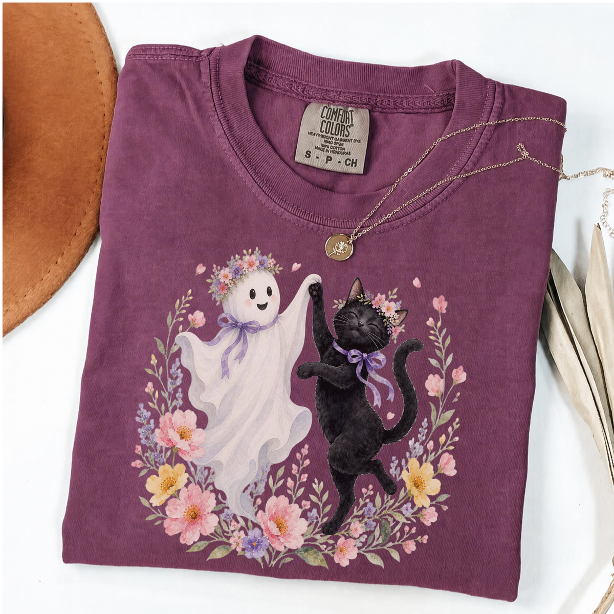 Berry Comfort Colors Halloween shirt featuring a floral ghost and black cat dancing together