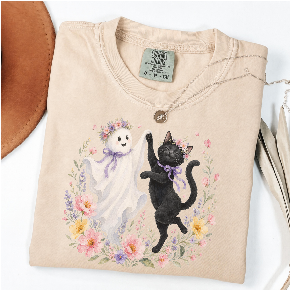 Ivory Comfort Colors Halloween shirt featuring a floral ghost and black cat dancing together