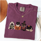 Berry Comfort Colors Halloween shirt featuring four black cats reading books in spooky costumes