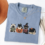 Blue Jean Comfort Colors Halloween shirt featuring four black cats reading books in spooky costumes
