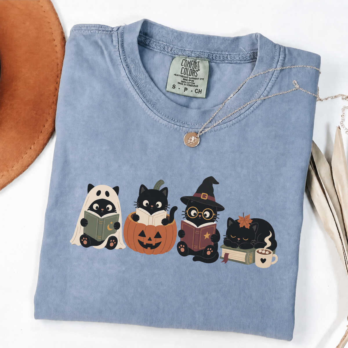 Blue Jean Comfort Colors Halloween shirt featuring four black cats reading books in spooky costumes
