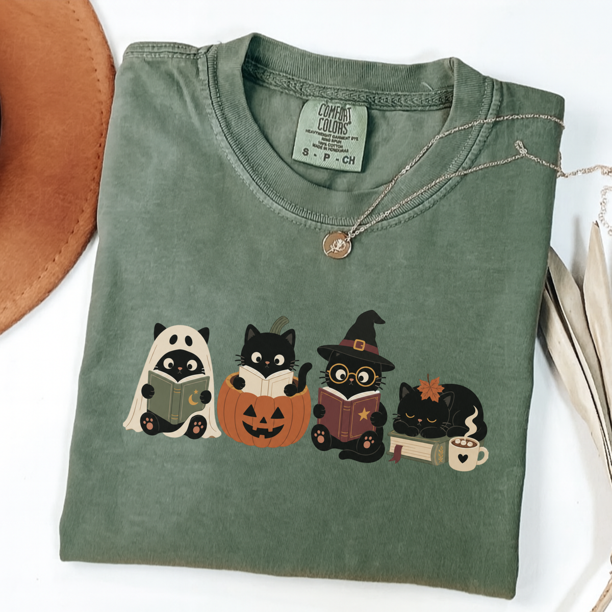 Moss Comfort Colors Halloween shirt featuring four black cats reading books in spooky costumes