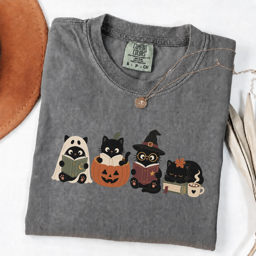 Pepper Comfort Colors Halloween shirt featuring four black cats reading books in spooky costumes