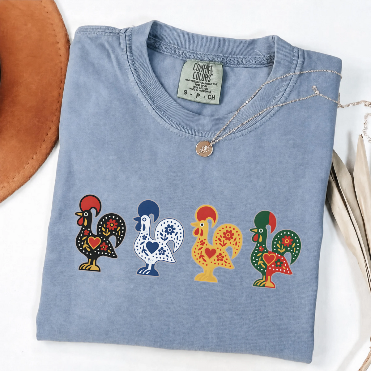 Blue Jean garment-dyed T-shirt featuring four colorful Portuguese folk-art roosters in a row
