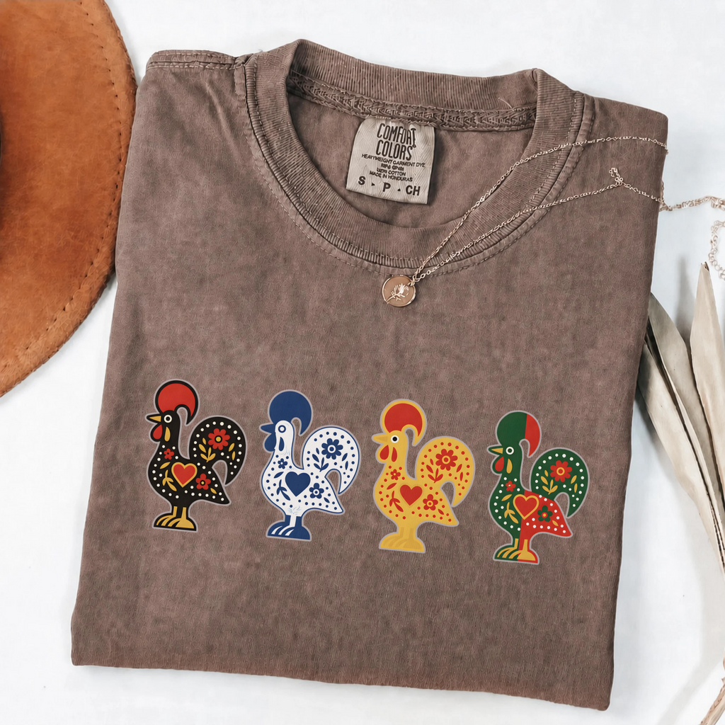 Espresso garment-dyed T-shirt featuring four colorful Portuguese folk-art roosters in a row