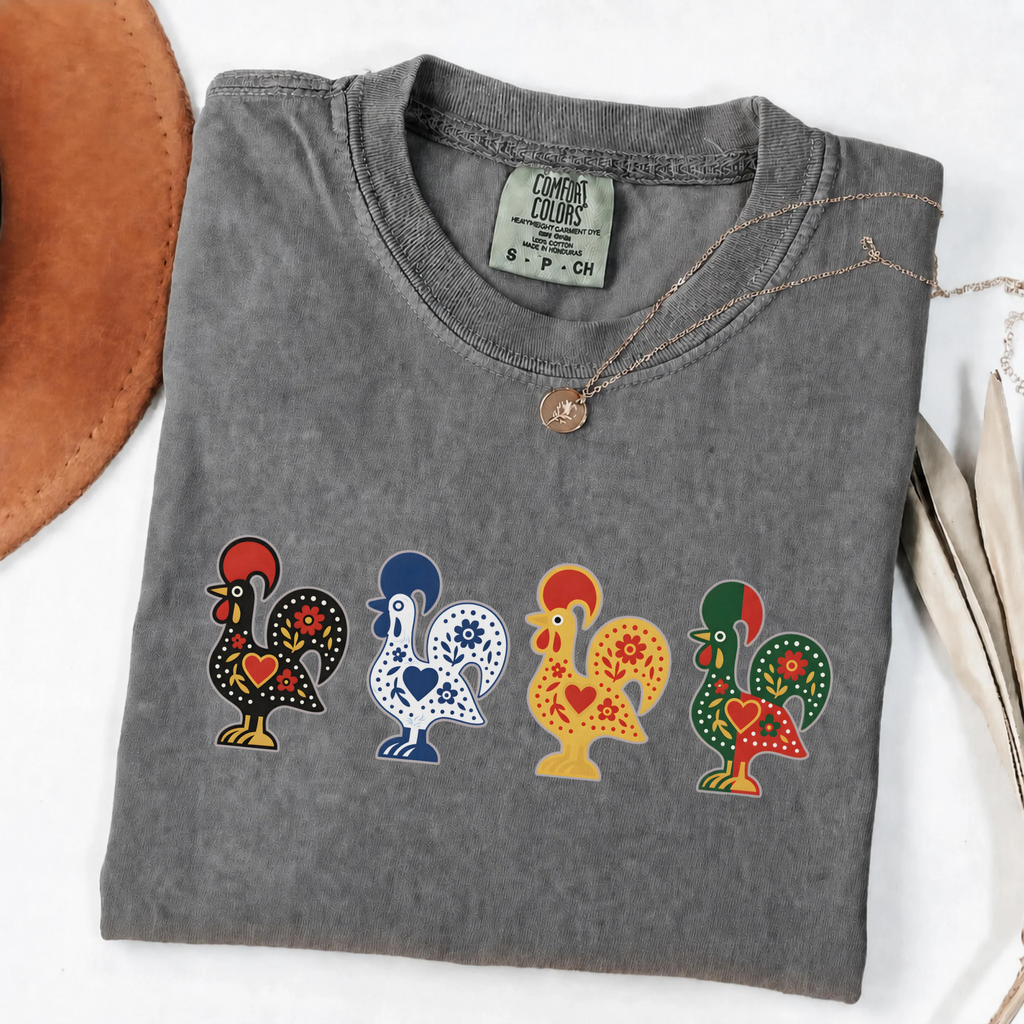 Pepper garment-dyed T-shirt featuring four colorful Portuguese folk-art roosters in a row
