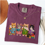 Berry T-shirt with four cartoon cats dressed as colorful pre-K teachers.