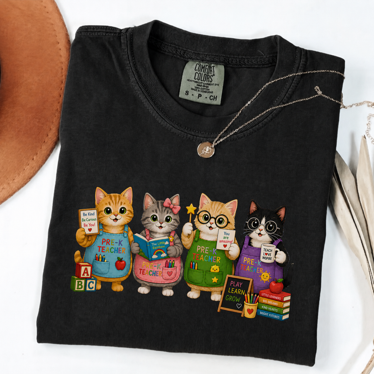 Black T-shirt with four cartoon cats dressed as colorful pre-K teachers.