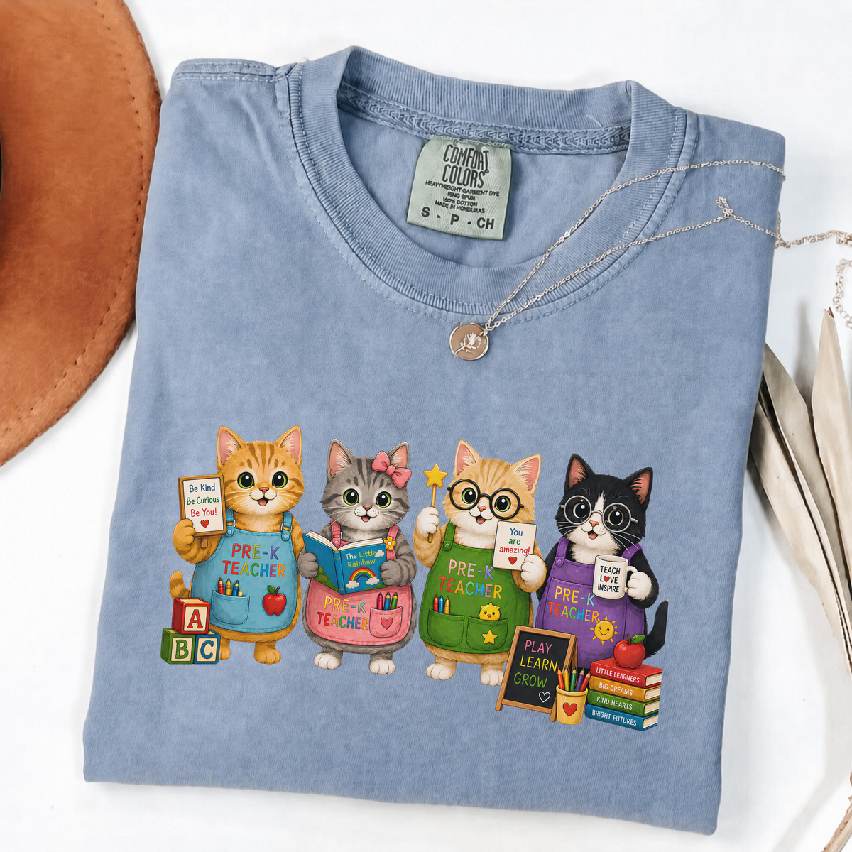 Blue Jean T-shirt with four cartoon cats dressed as colorful pre-K teachers.