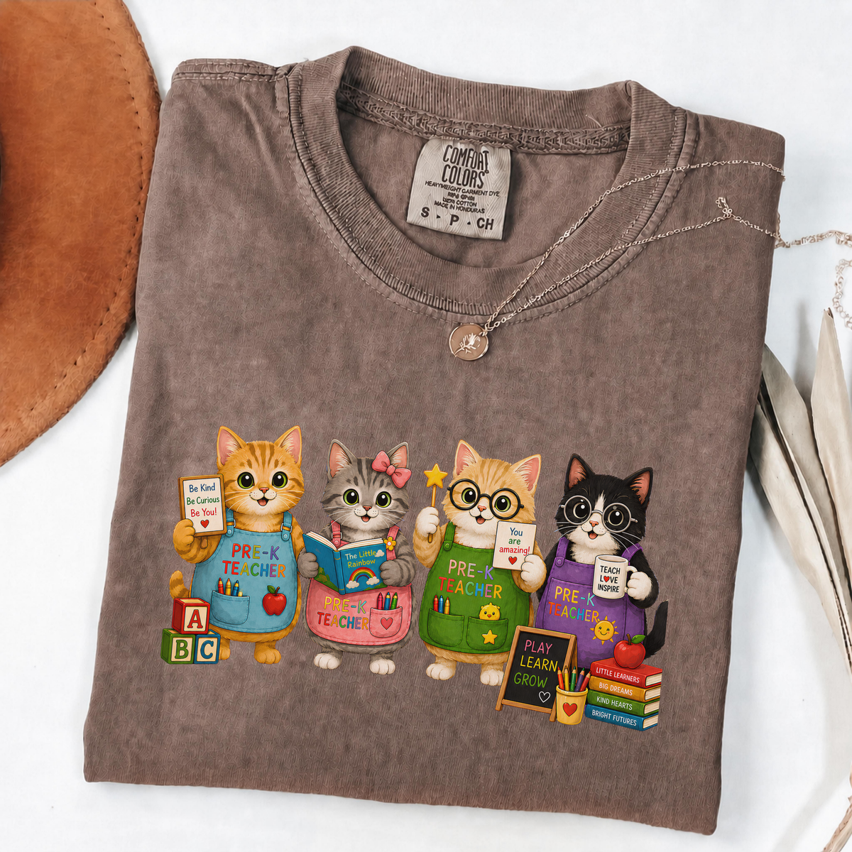 Espresso T-shirt with four cartoon cats dressed as colorful pre-K teachers.